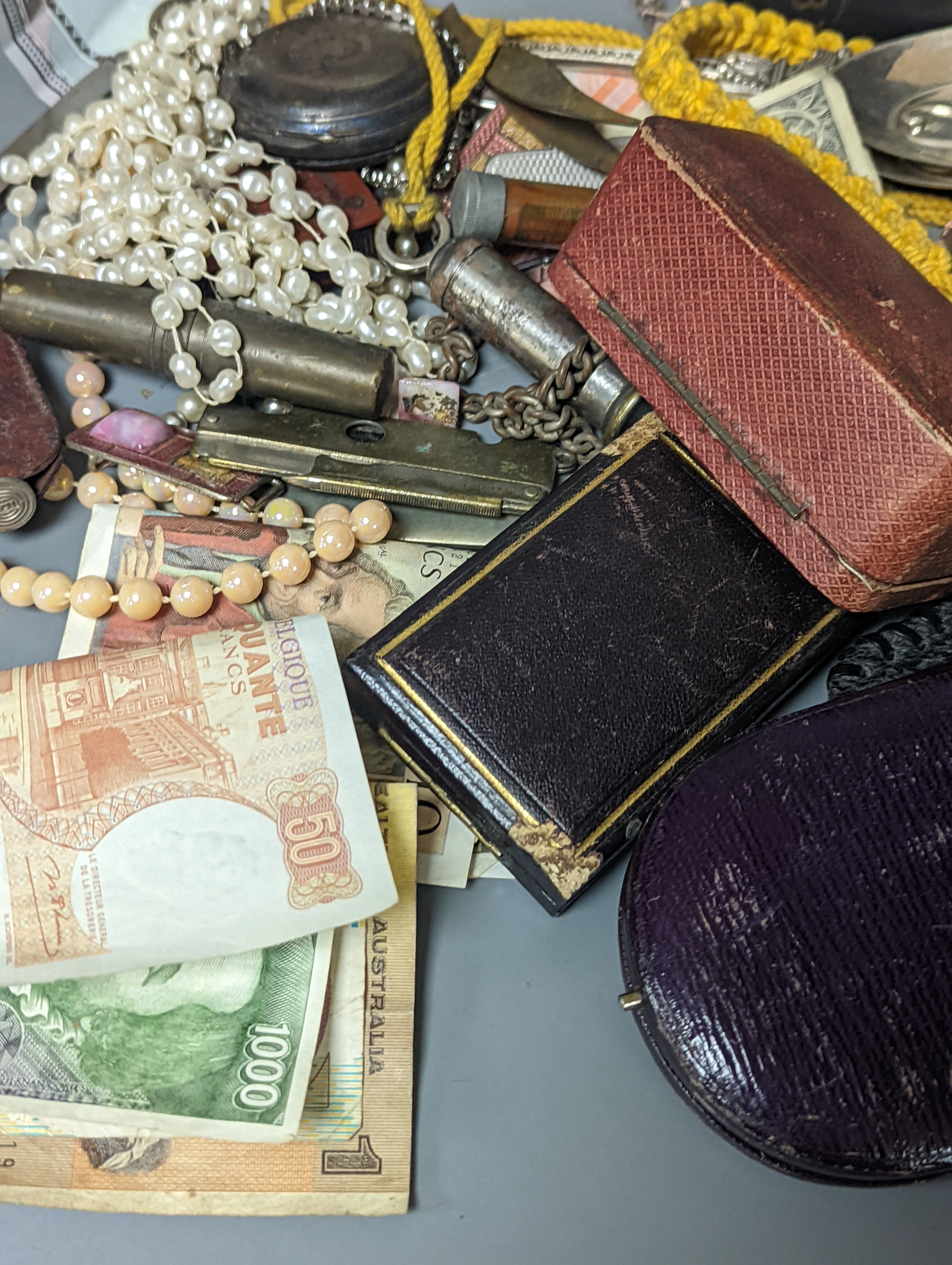 A pair of silver spoons, a small timepiece, assorted coinage and sundries